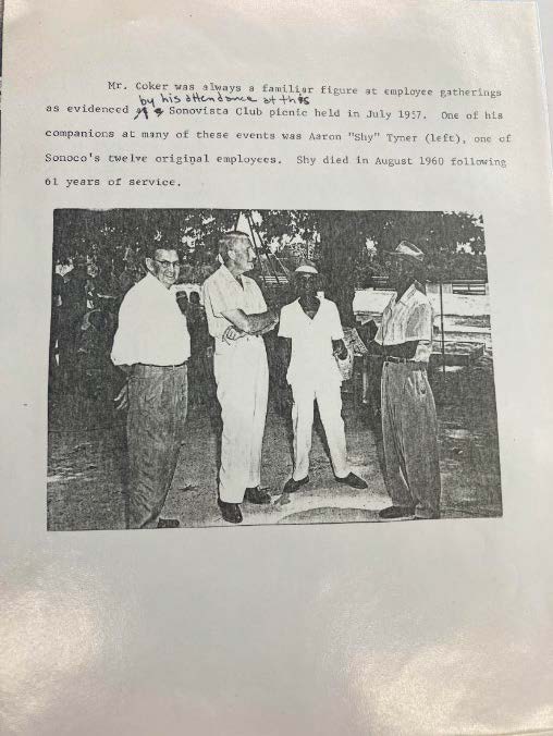 Paper with old black and white image and text from typewriter. Text reads "Mr. Coker was always a familiar figure at employee gatherings as evidenced [edit written in: by his attendance at this] Sonovista Club picnic held in July 1957. One of his ocmpanions at many of these events was Aaron "Shy" Tyner (left), one of Sonoco's twelve original employees. Shy died in August 1960 following 61 years of service." Image depicts four men.